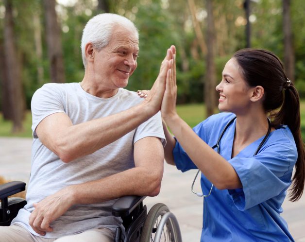 nurse-old-man-wheelchair-high-five